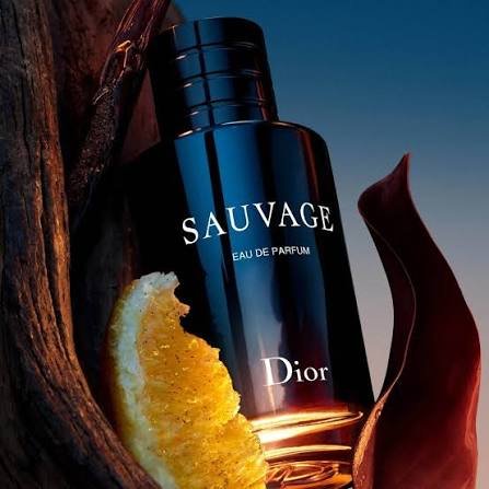 holding a bottle of Dior Sauvage Eau de Parfum